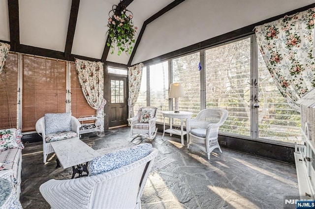 sunroom with vaulted ceiling with beams