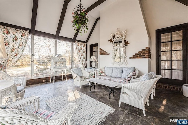 sunroom / solarium with vaulted ceiling with beams