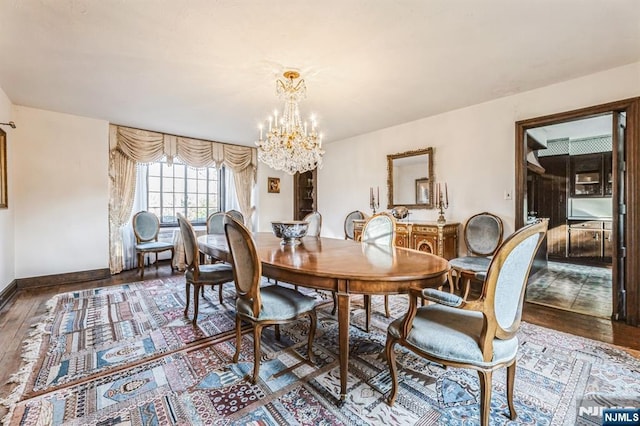 dining room with hardwood / wood-style flooring and a notable chandelier