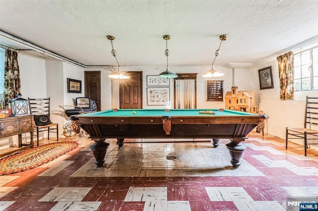 playroom featuring pool table and a textured ceiling