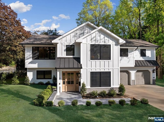 modern farmhouse style home with a standing seam roof, board and batten siding, an attached garage, and a front lawn