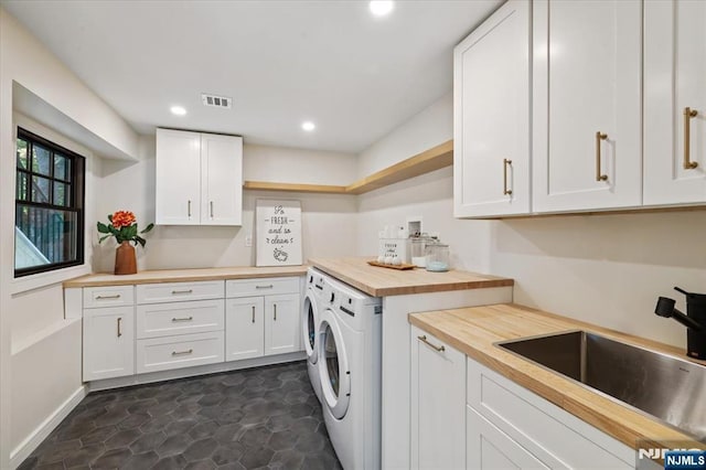 laundry room featuring cabinet space, recessed lighting, and separate washer and dryer