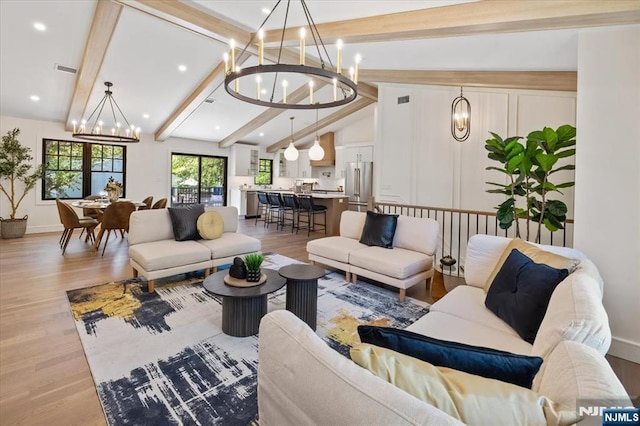 living room with a chandelier, light wood finished floors, recessed lighting, and baseboards