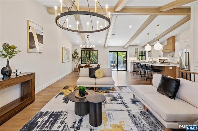 living room with a chandelier, light wood-style flooring, recessed lighting, and baseboards