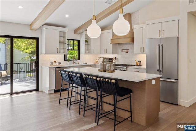 kitchen with stainless steel appliances, open shelves, tasteful backsplash, light wood finished floors, and recessed lighting