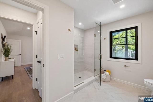 full bath with baseboards, a stall shower, toilet, recessed lighting, and wood finished floors