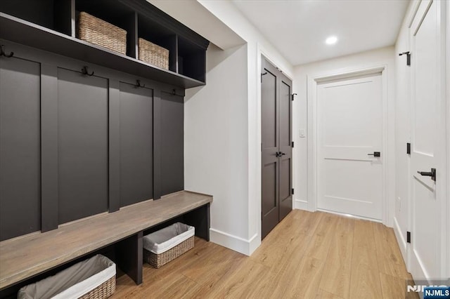 mudroom with wood finished floors, baseboards, and recessed lighting