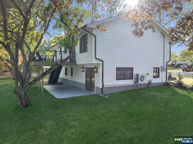 back of property with a patio, ac unit, stairway, and a yard