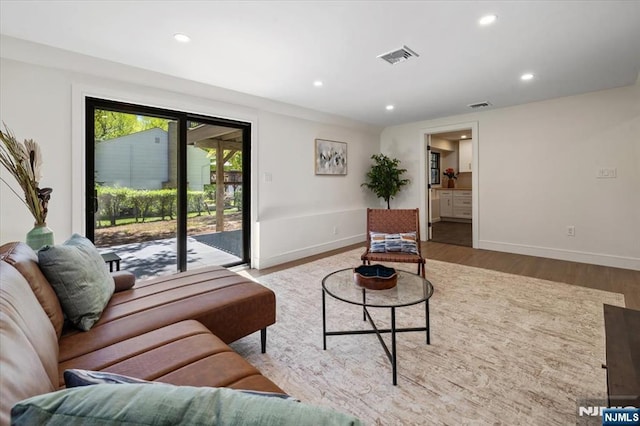 living room with wood finished floors, recessed lighting, and baseboards