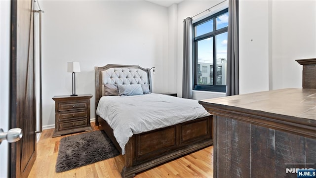 bedroom with light hardwood / wood-style floors