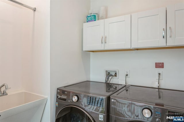 washroom featuring cabinets, washer and dryer, and sink