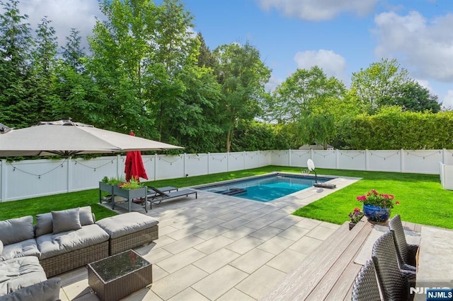 view of swimming pool with a patio, outdoor lounge area, and a lawn