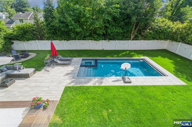 view of swimming pool with a yard, a fire pit, and a patio