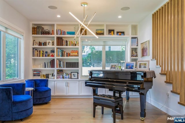 living area featuring built in features and light wood-type flooring