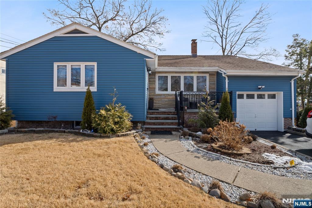 single story home with a garage and a front yard