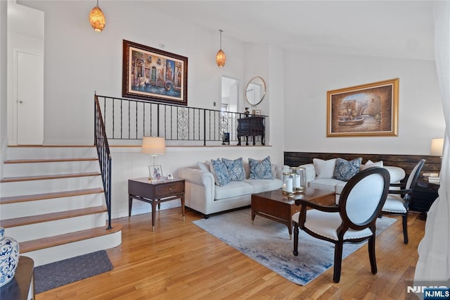 living room with hardwood / wood-style flooring and vaulted ceiling