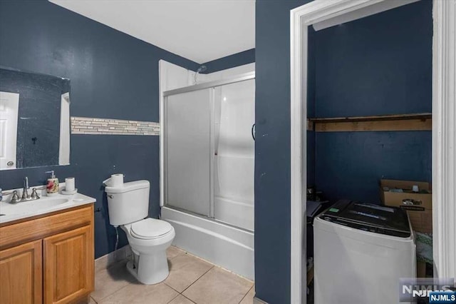 full bathroom featuring tile patterned flooring, vanity, toilet, and combined bath / shower with glass door