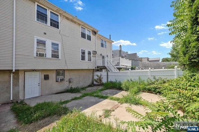 back of property with a patio and cooling unit