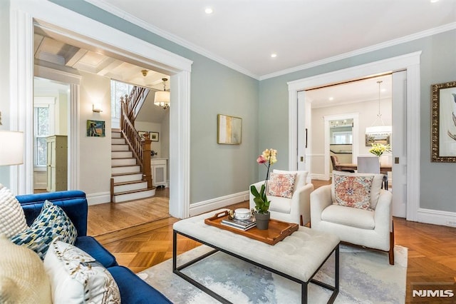 living room featuring ornamental molding, parquet flooring, and a notable chandelier