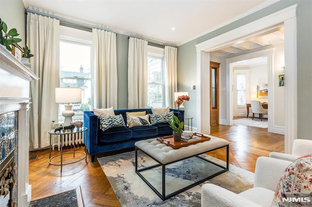 living room featuring crown molding, parquet flooring, a high end fireplace, and plenty of natural light