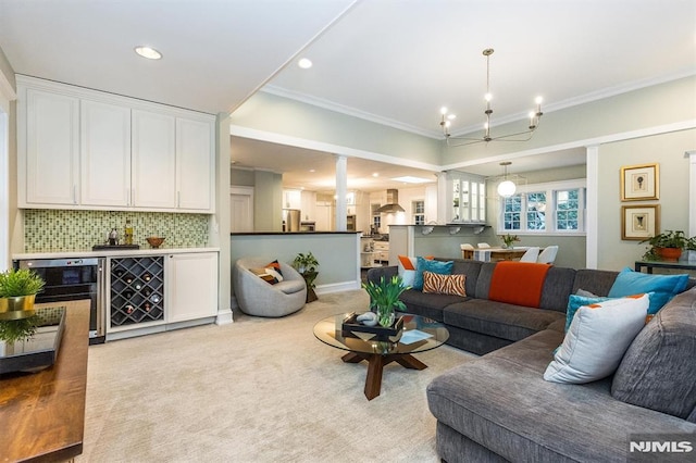 living room with ornamental molding, light colored carpet, and wine cooler