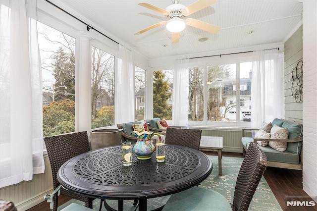 sunroom / solarium featuring ceiling fan and plenty of natural light