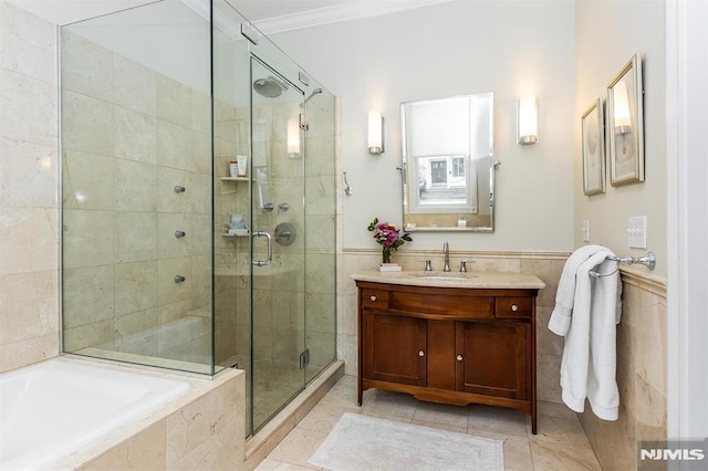 bathroom with shower with separate bathtub, tile walls, ornamental molding, vanity, and tile patterned flooring