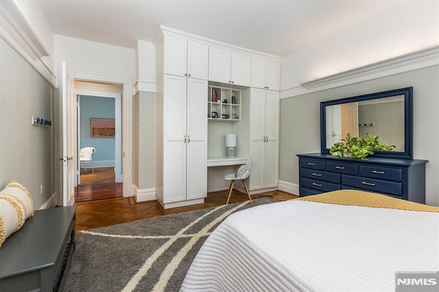 bedroom featuring dark parquet floors