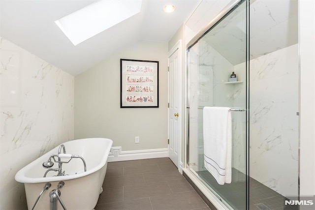 bathroom featuring independent shower and bath and vaulted ceiling with skylight