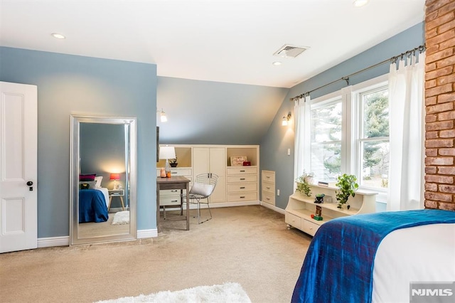 carpeted bedroom with lofted ceiling