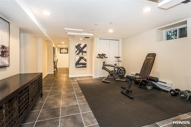 workout room with dark tile patterned floors