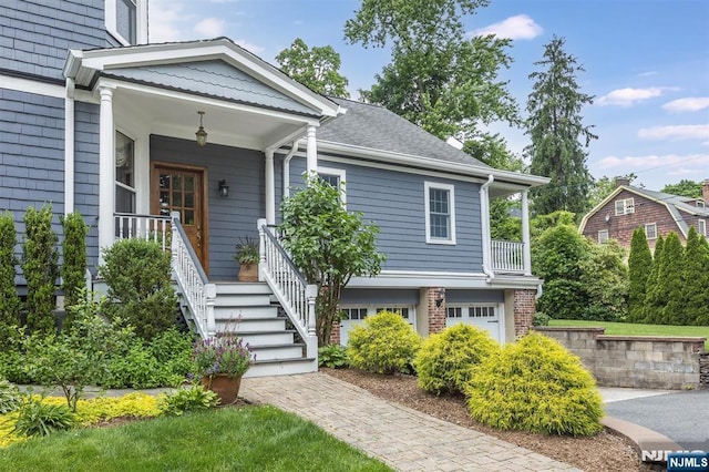 view of front of home featuring a garage and a porch