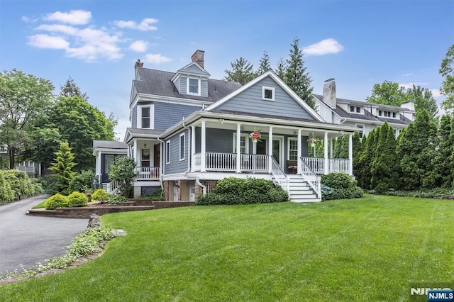 view of front of home with a porch and a front yard