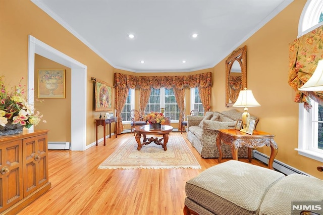 living area with a baseboard radiator, baseboards, crown molding, and light wood finished floors