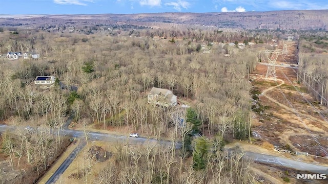 birds eye view of property featuring a view of trees