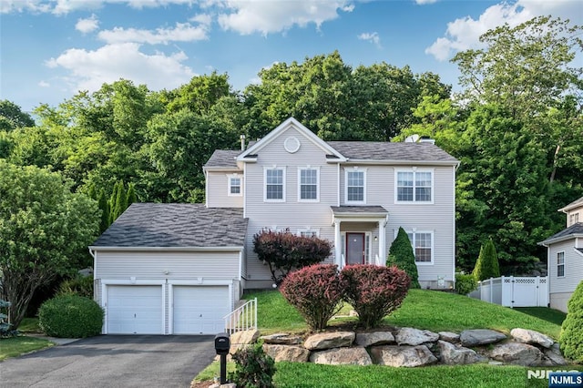 view of front of house featuring a garage and a front yard