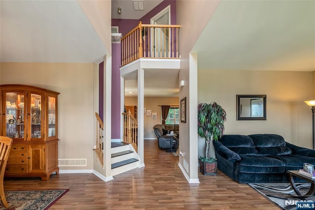 entrance foyer featuring hardwood / wood-style floors and a towering ceiling