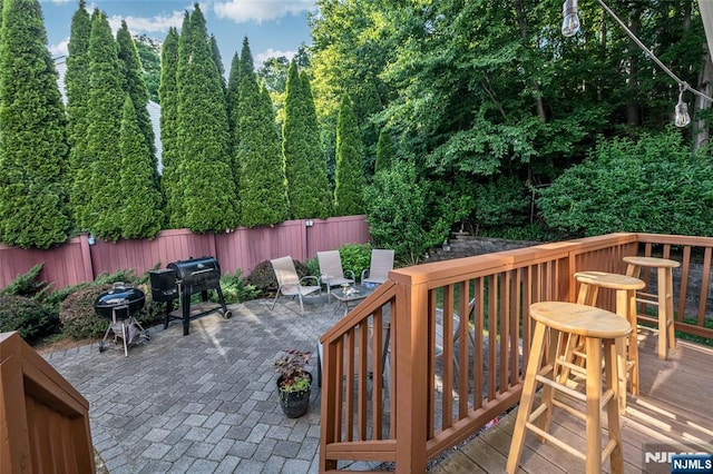 deck featuring a patio, an outdoor bar, and grilling area