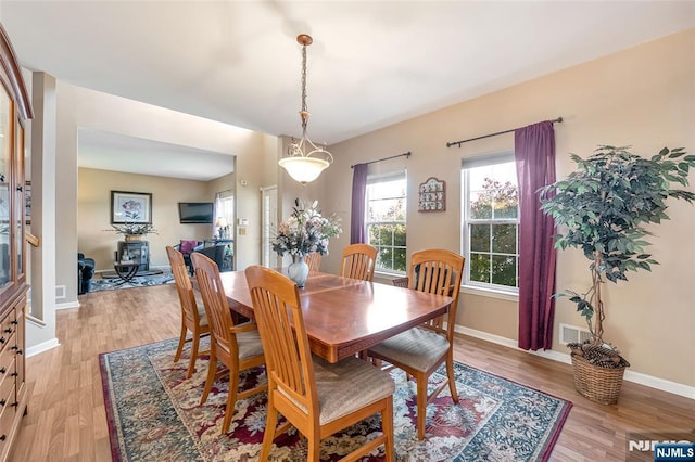 dining space with light hardwood / wood-style floors