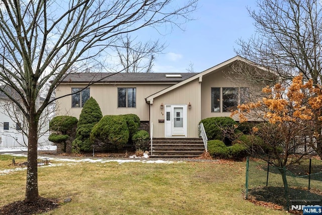 split foyer home with a front lawn