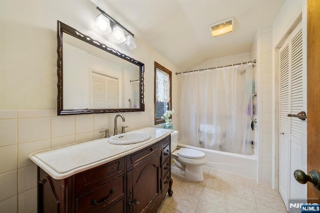 full bathroom with tile walls, vanity, shower / bath combination with curtain, tile patterned floors, and toilet