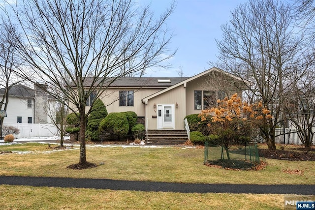 bi-level home with a front lawn