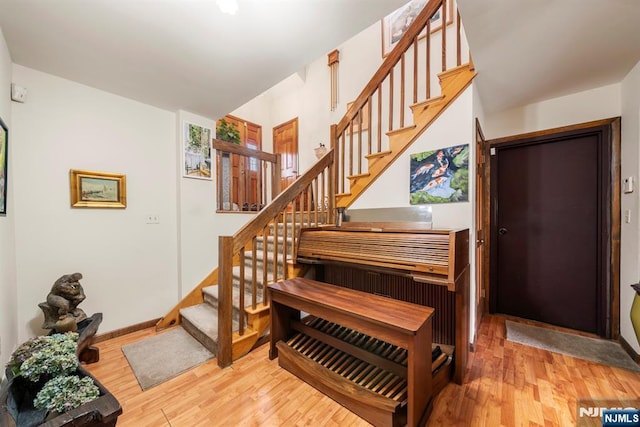 staircase with hardwood / wood-style flooring