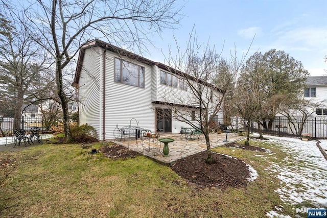 rear view of property featuring a yard and a patio