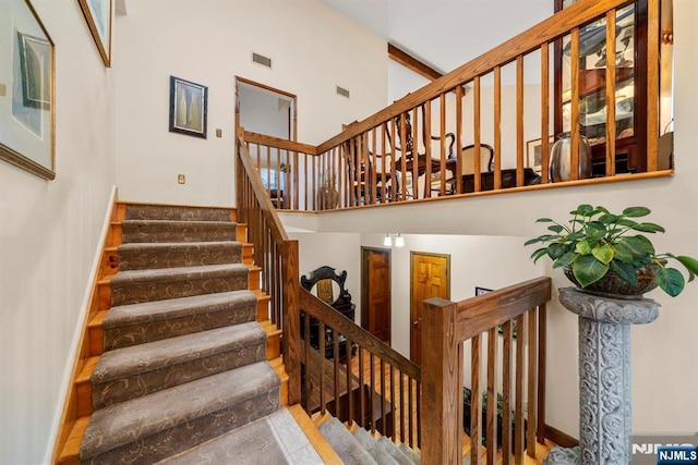 stairway featuring a high ceiling