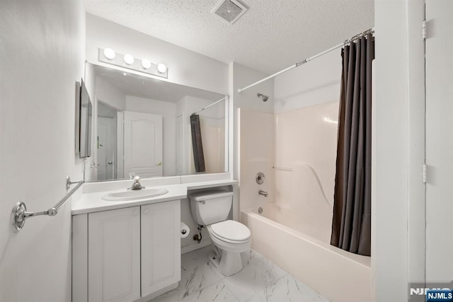 full bathroom with vanity, toilet, a textured ceiling, and shower / bath combo with shower curtain