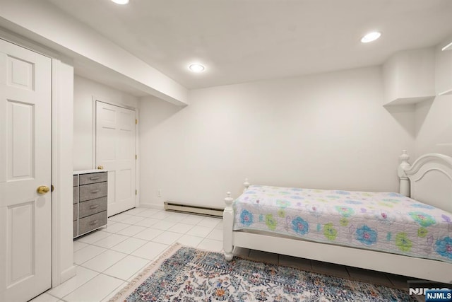 bedroom featuring a baseboard radiator and light tile patterned floors