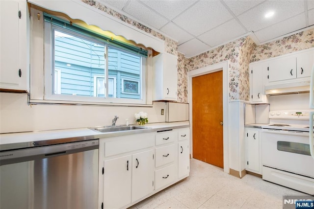 kitchen featuring electric stove, sink, a paneled ceiling, white cabinets, and stainless steel dishwasher