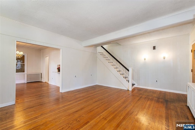 interior space featuring hardwood / wood-style flooring, a chandelier, and a textured ceiling