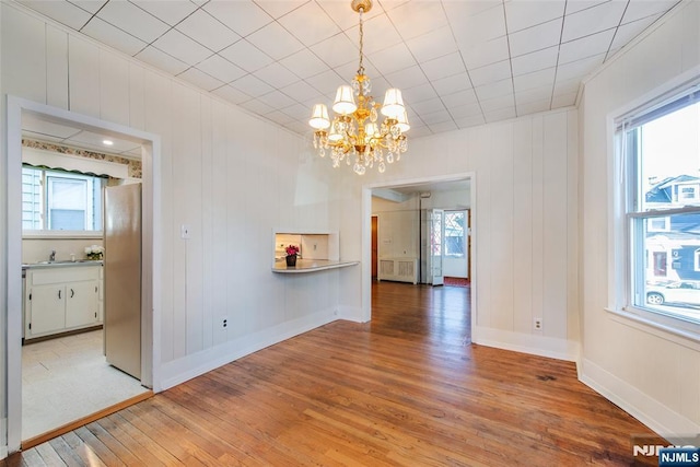 interior space with hardwood / wood-style flooring, sink, and an inviting chandelier